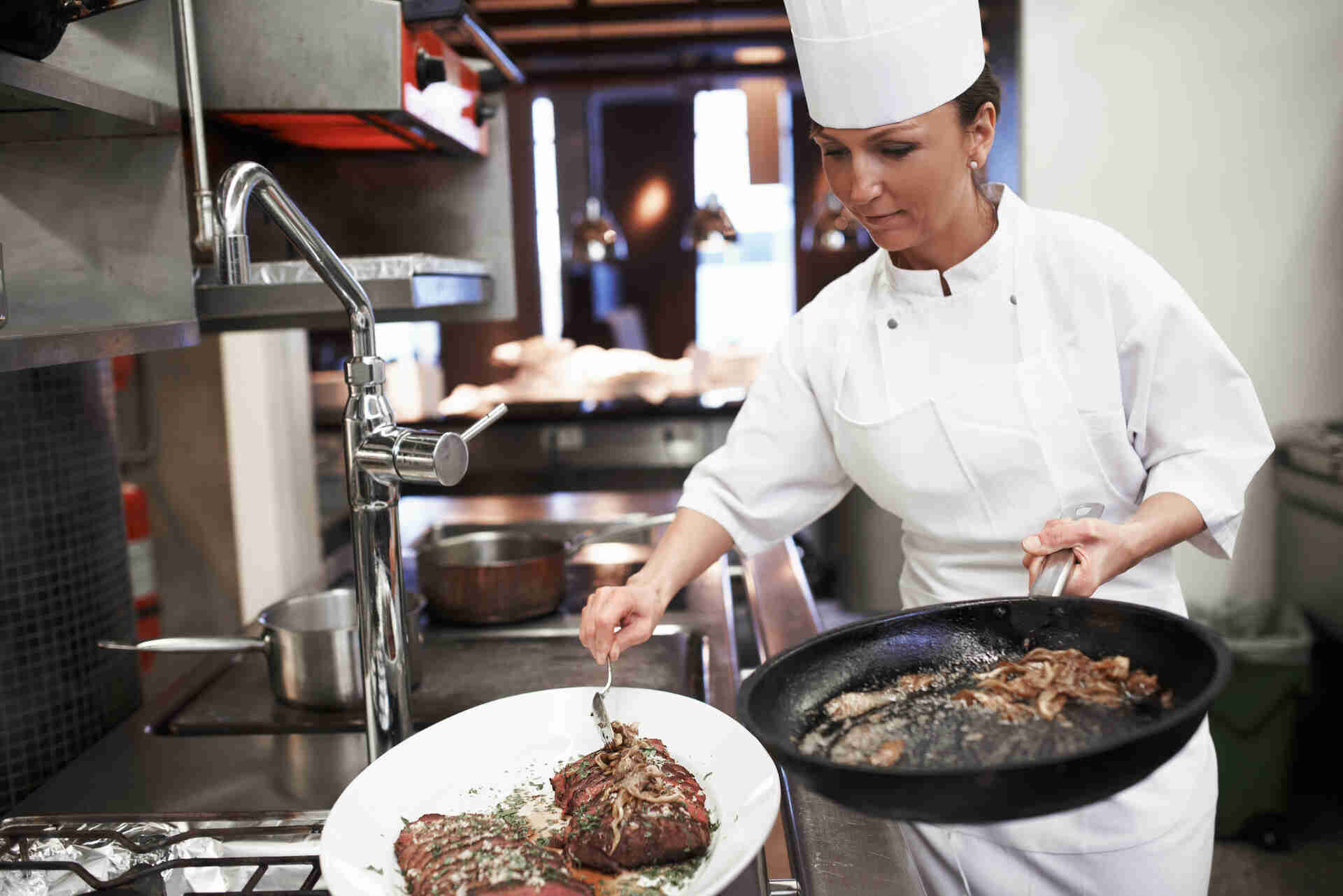 Chef preparing plate in a colorado steakhouse