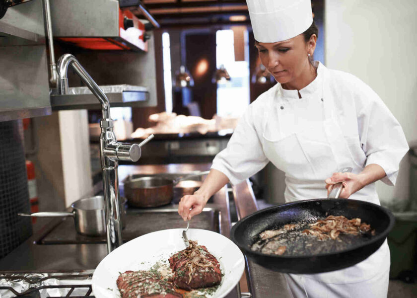 Chef preparing plate in a colorado steakhouse