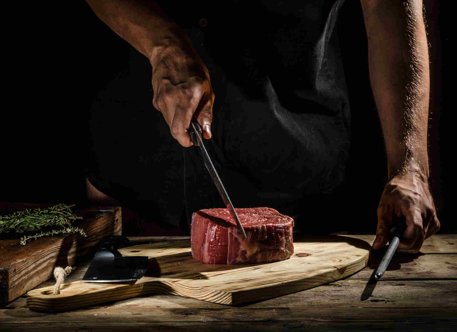 chef at driven steak house in colorado preparing a steak