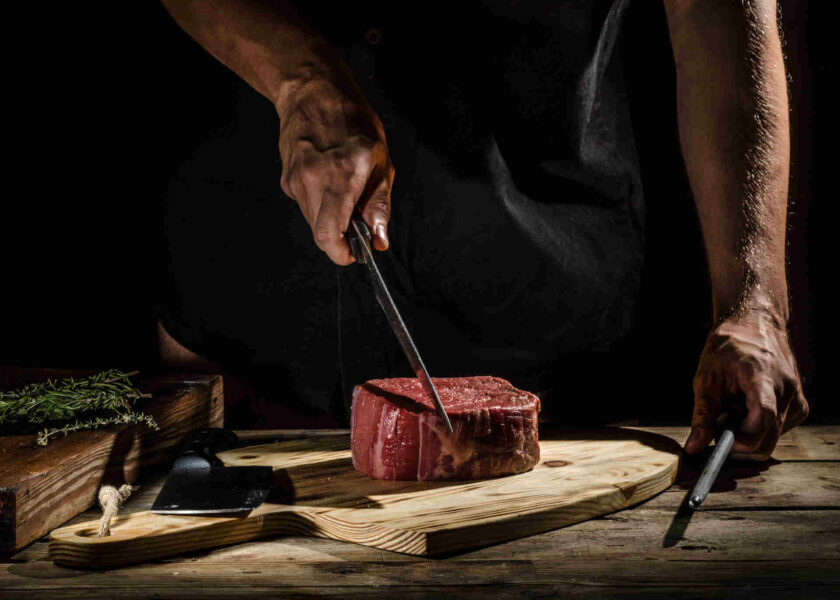 chef at driven steak house in colorado preparing a steak